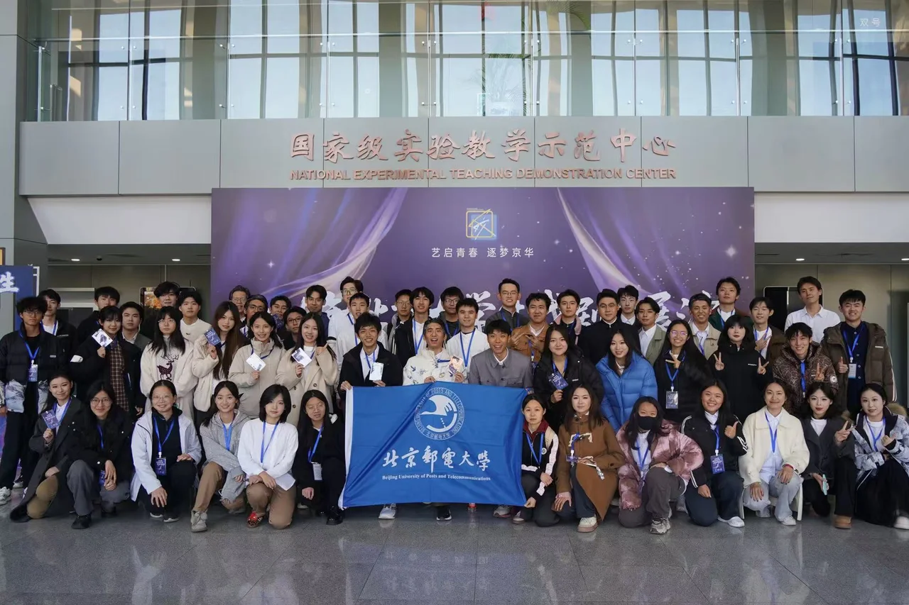 The company posing with a BUPT flag in front of the National Experimental Teaching Demonstration Center