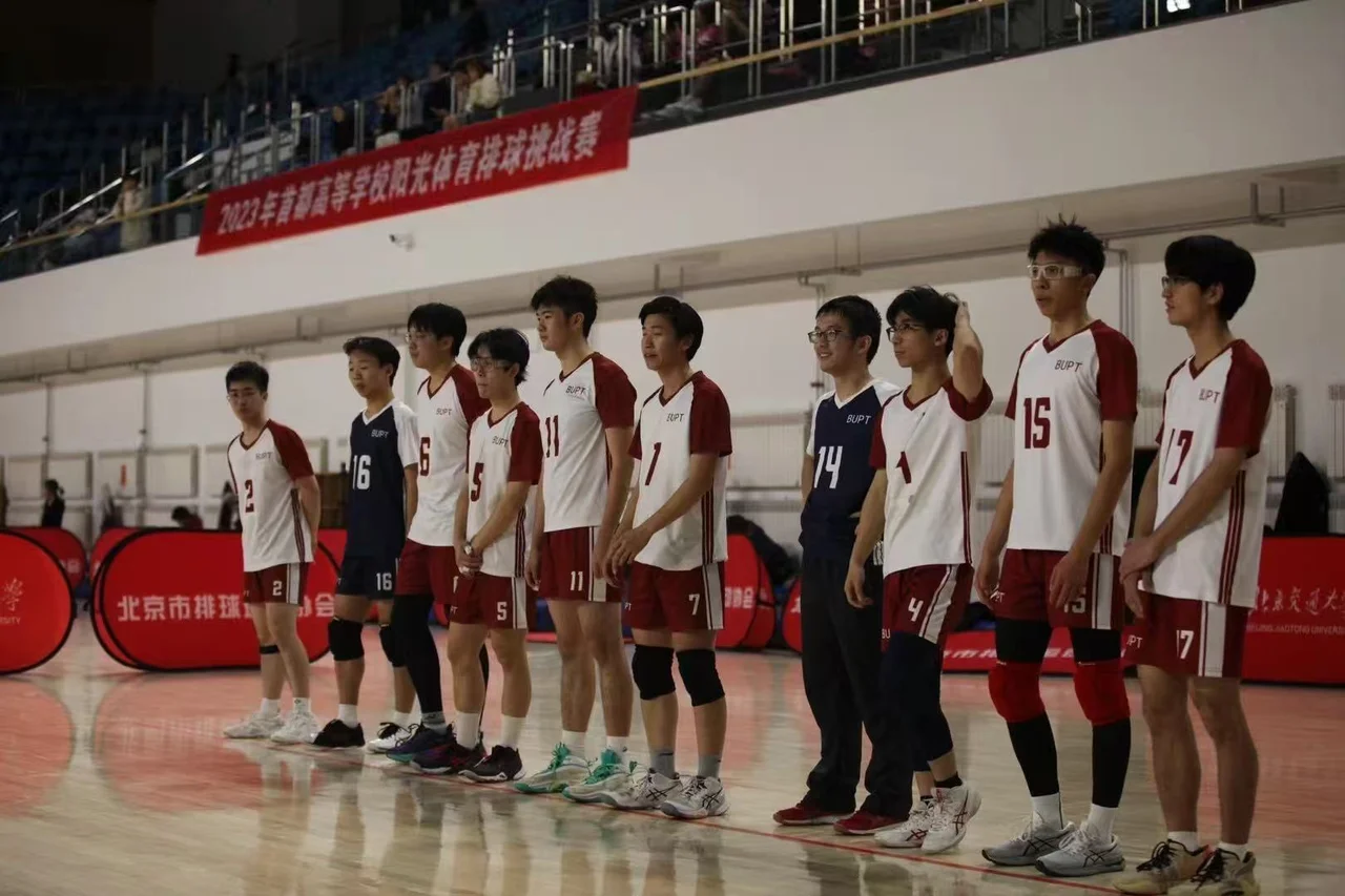 University volleyball teammates in BUPT jerseys standing side by side in a row on an indoor court