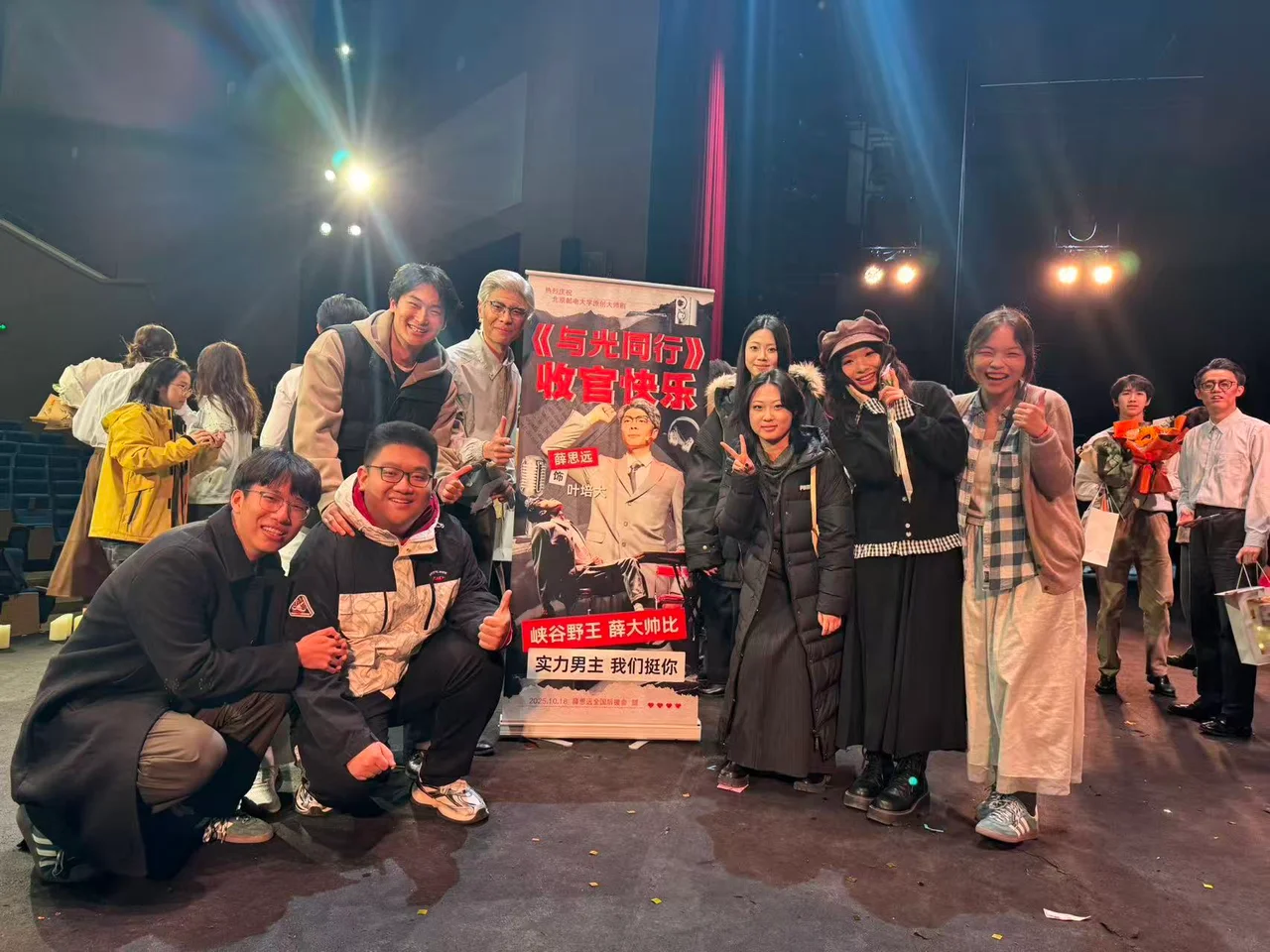 A photo with friends after the performance, gathered around a poster reading Siyuan Xue as Ye Peida